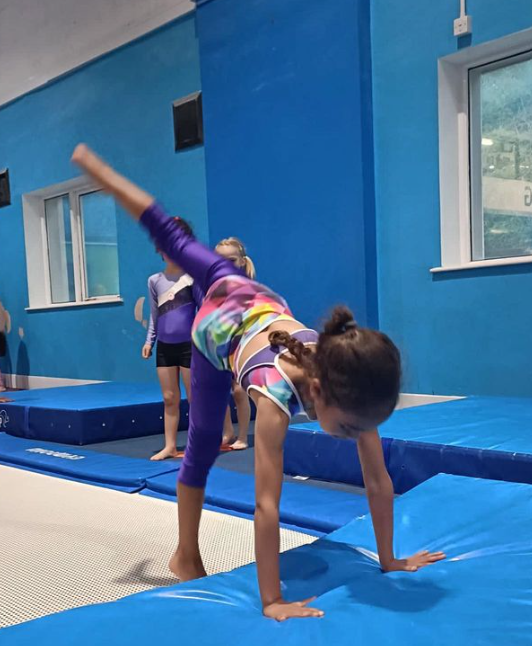 Child practising a beginner handstand at Manchester Academy of Gymnastics
